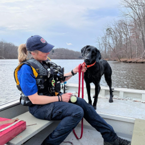Black lab with handler on Boat
