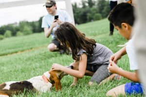 children petting beagles at Dog Daze event