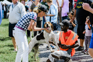 People petting foxhound at Dog Daze event